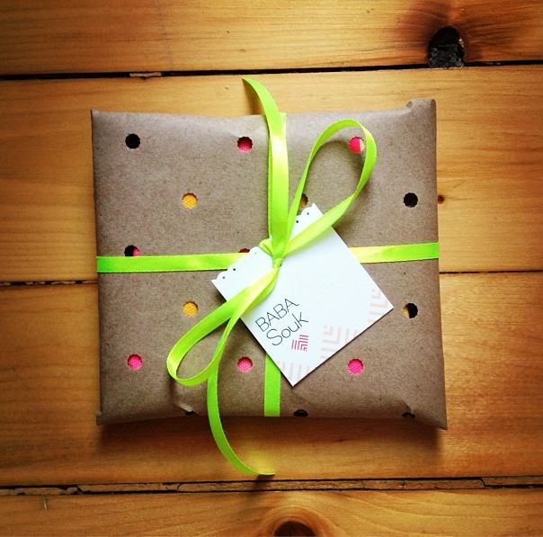 punch holes in brown craft paper and show birthday or Christmas gift wrapping un...