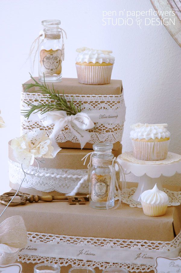 Love the simplicity of lace around brown paper wrapped boxes for dressing up the...