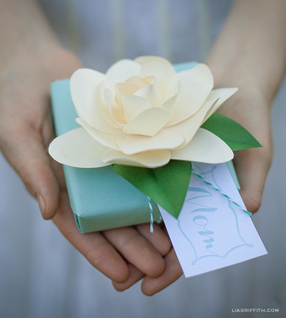 DIY Paper Gardenia - Make one of these paper gardenias to top a gift #giftwrap #...