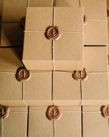 boxes with anchors stamped in a gold wax seals