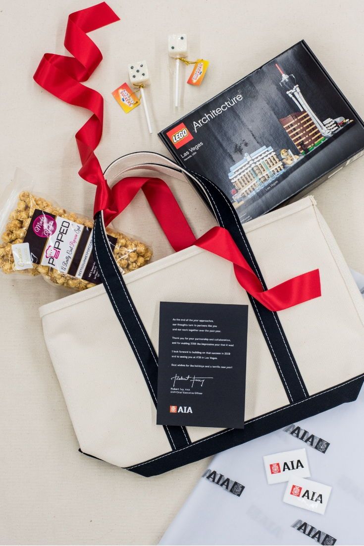 CORPORATE EVENT GIFTS// Red and cream corporate company event gift totes welcome...