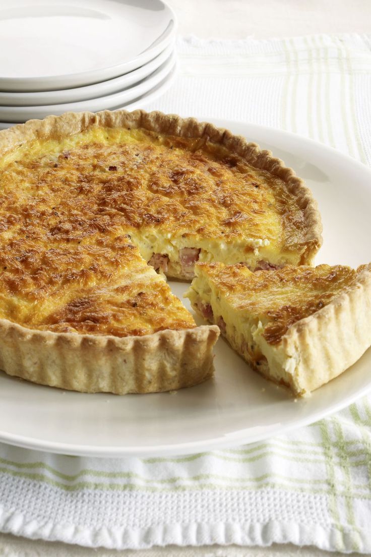 A deep-dish quiche filled with cheese and bacon is just want Mom wants to dive i...