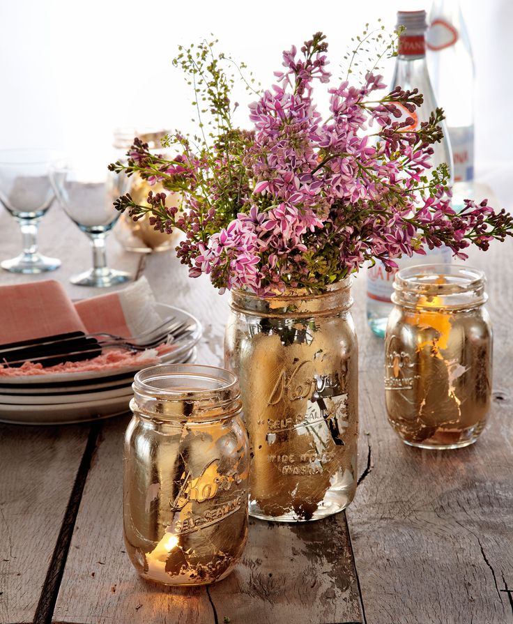 Upgrade your picnic table with gilded DIY vases and votives. Use a foam brush to...