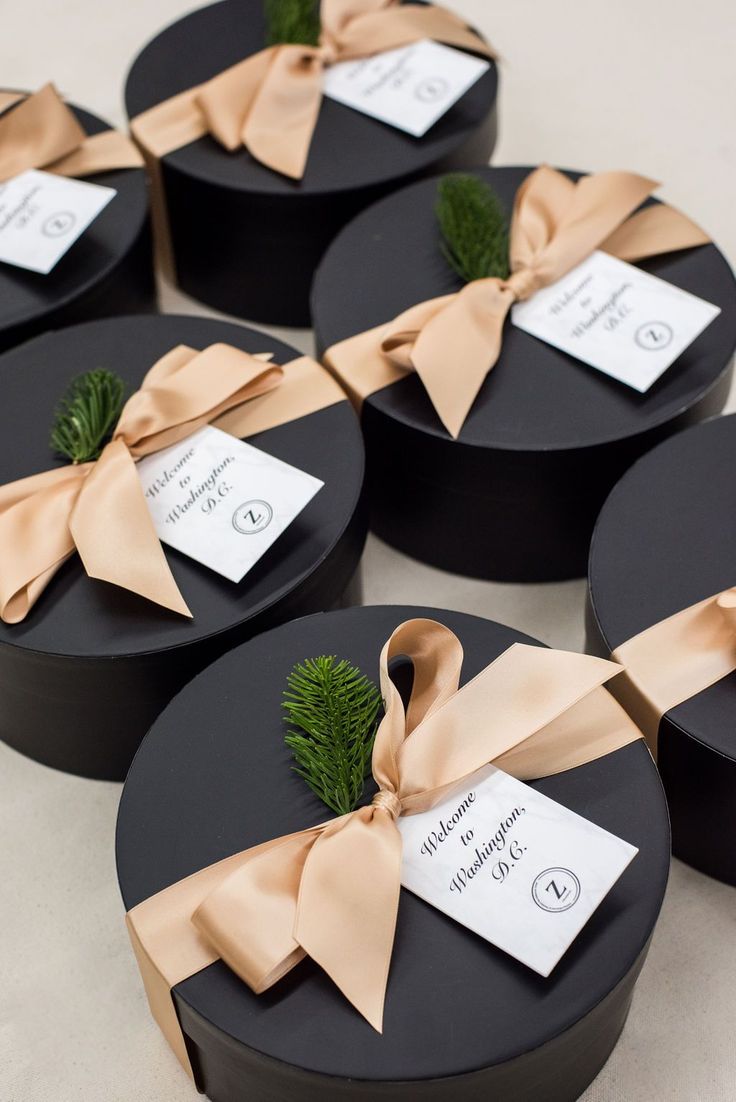 CORPORATE GIFTS// Luxurious black hatboxes welcome business professionals to a c...