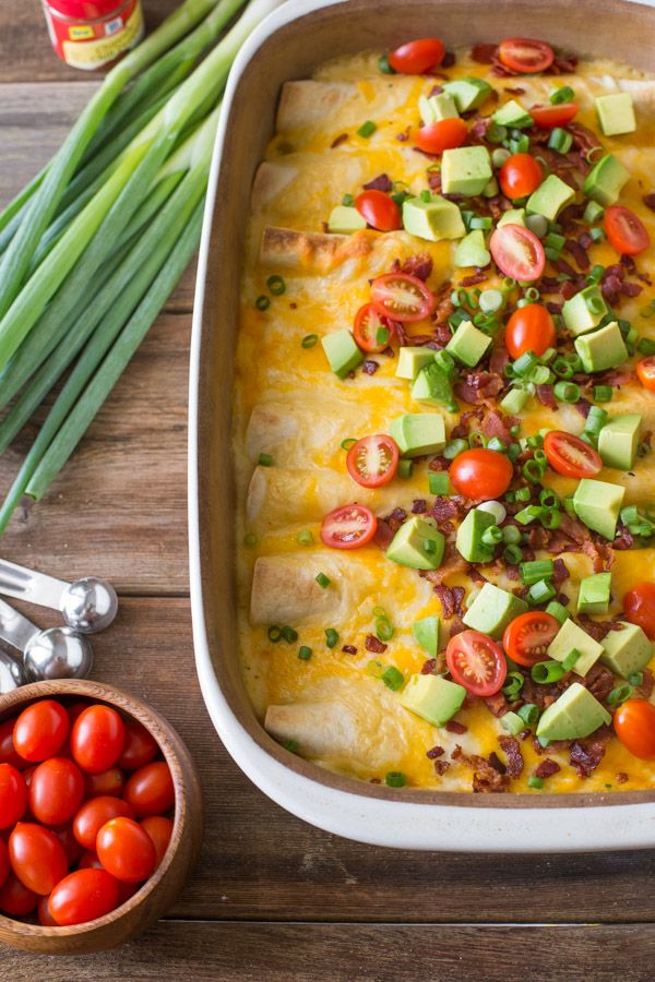 Breakfast Enchilada Bake is loaded with fluffy eggs and bacon, and topped with c...