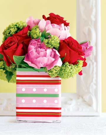 Cluster pink peonies and tulips, red roses, and chartreuse verbena in an oversiz...