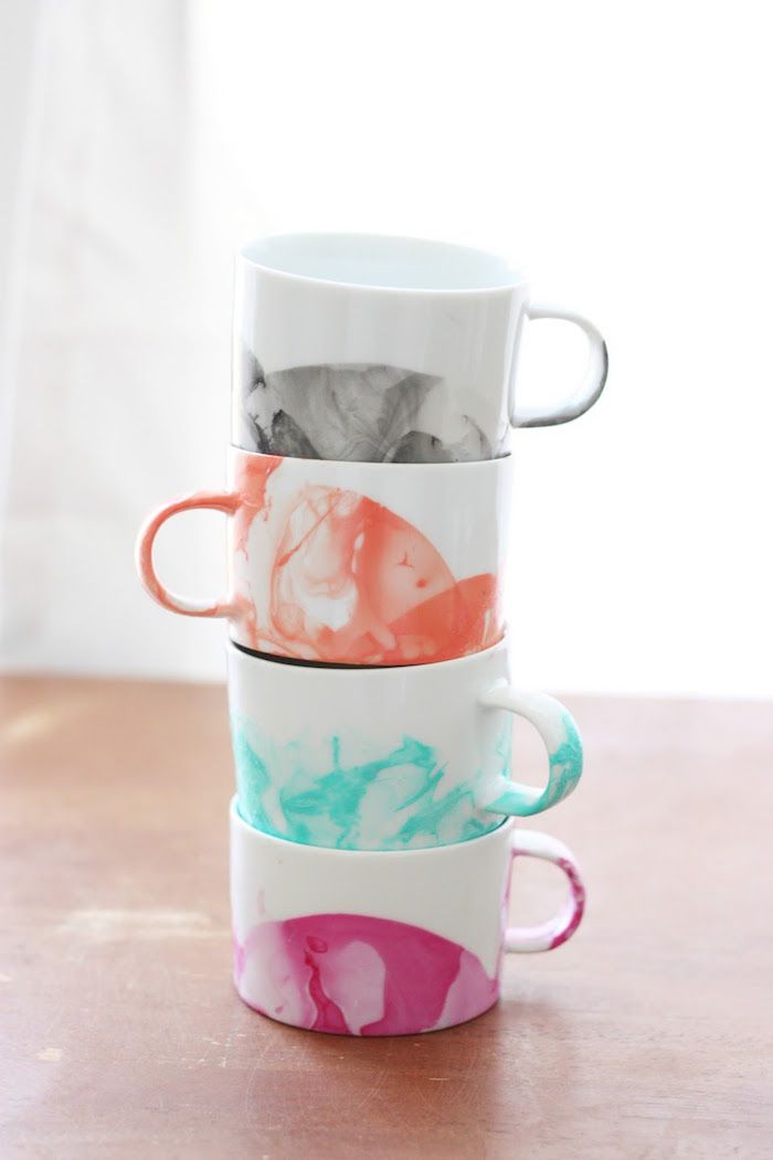 DIY Marbled Mugs are super easy to craft at home. Use colored nail polish to cre...