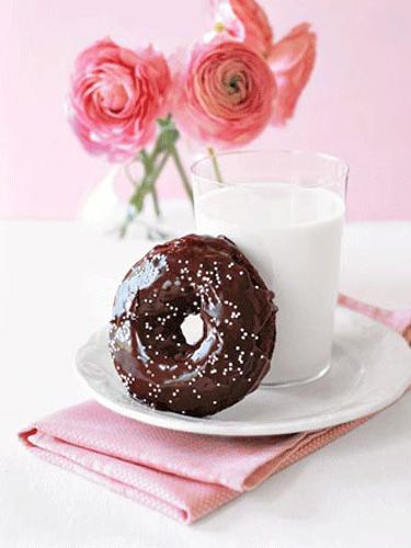 Double-Chocolate Doughnut is adorned with a flurry of white sprinkles and paired...