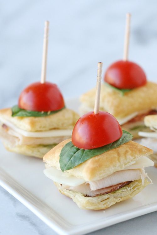 Turkey Pesto Appetizer Bites feature turkey and pesto in between flaky puff past...