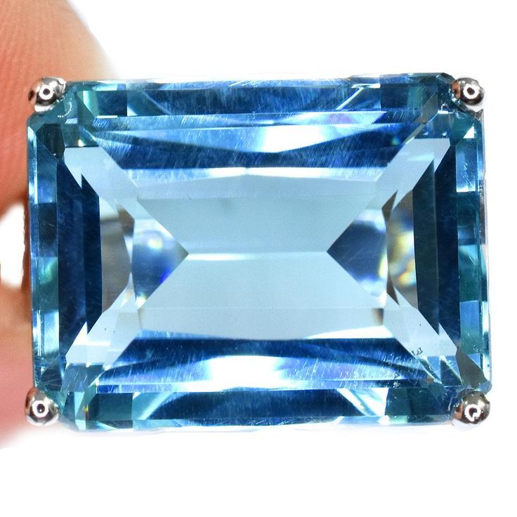 An East West 16.7CT Emerald Cut Blue Aquamarine Ring