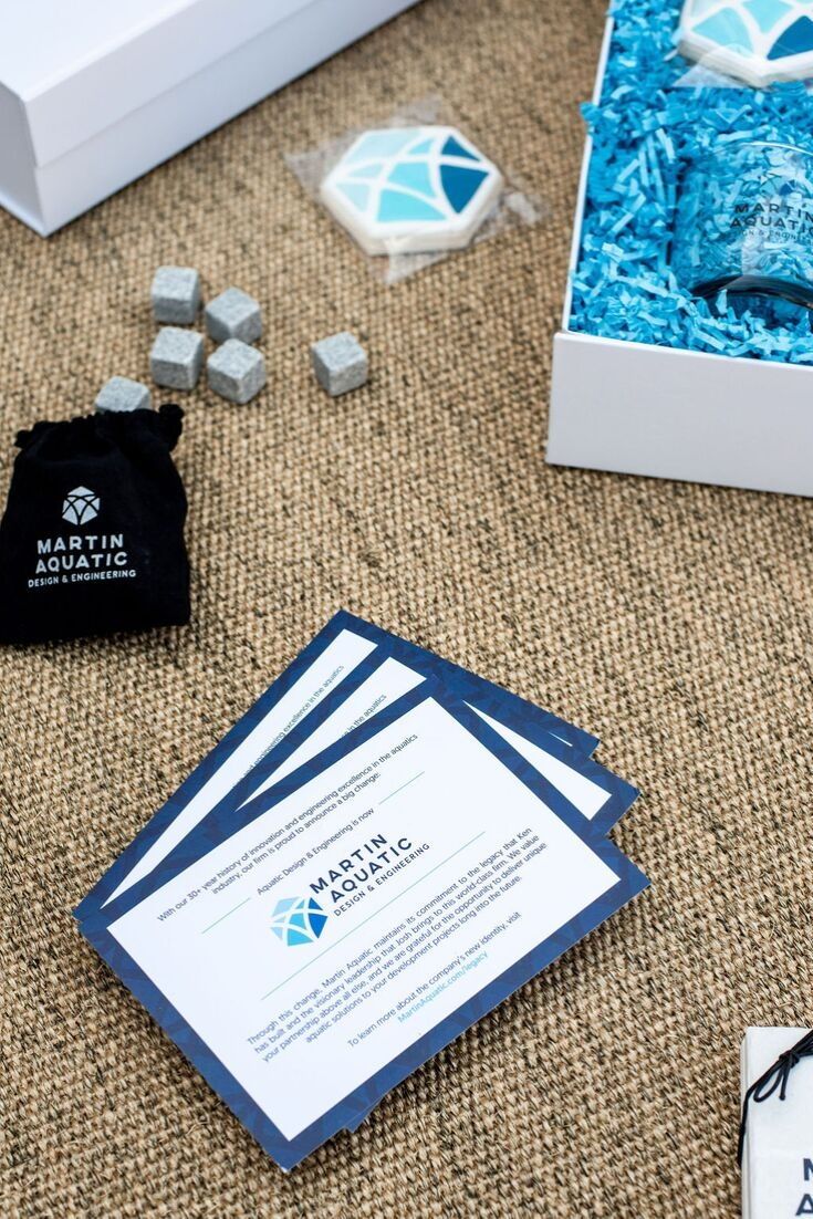 CORPORATE EVENT GIFTS// Blue and white on-brand gift boxes welcome business part...