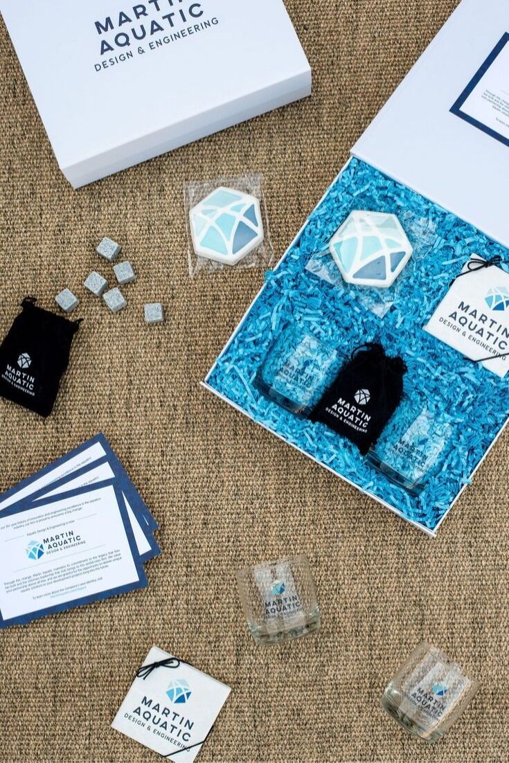 CORPORATE EVENT GIFTS// Blue and white on-brand gift boxes welcome business part...