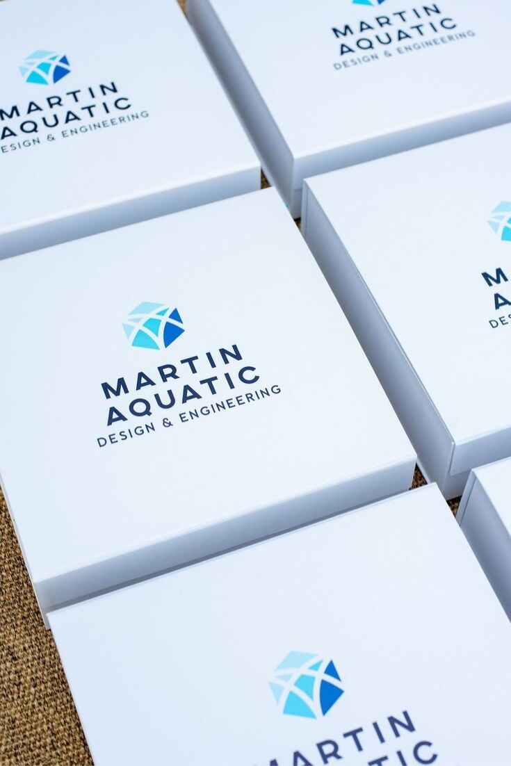 CORPORATE EVENT GIFTS// Blue and white on-brand gift boxes welcome business part...