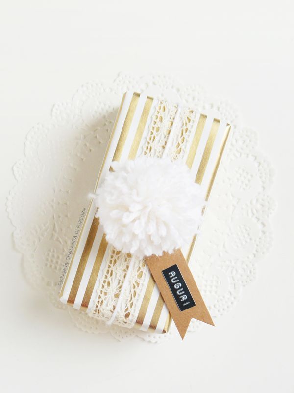 White pompom and golden wrapping paper.