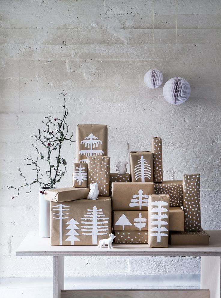 Christmas presents are wrapped with brown kraft paper. Decorations are made from...